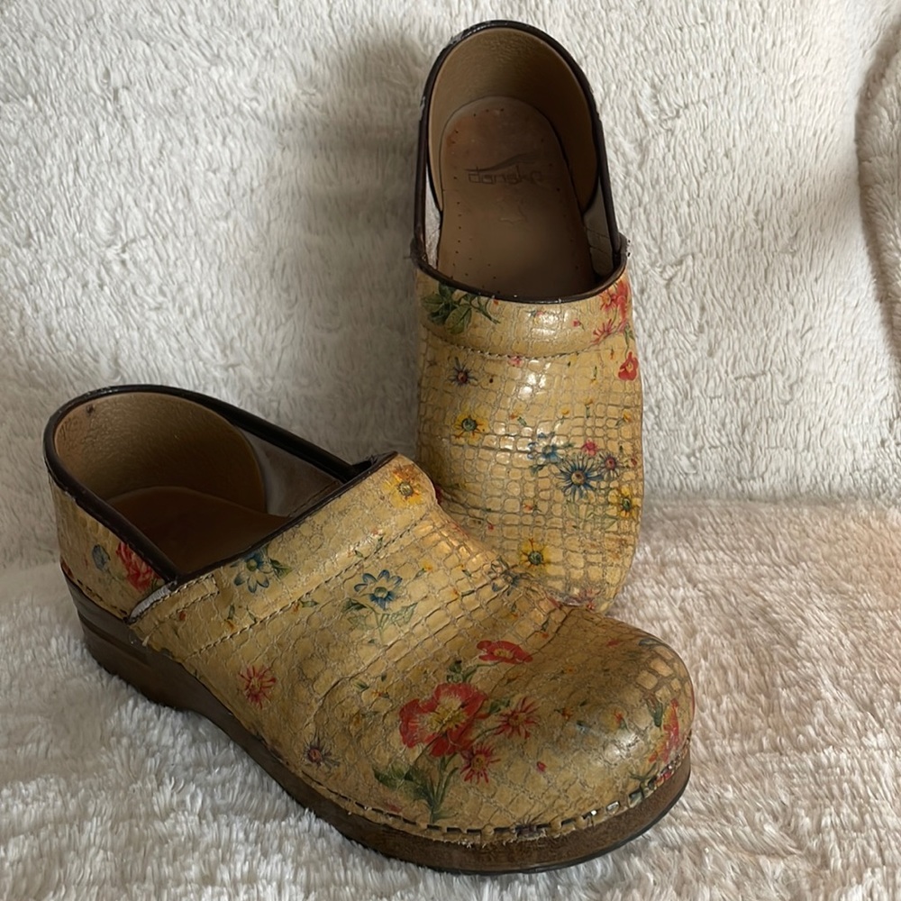 8.5 Dansko-brand flowered, yellow clogs.